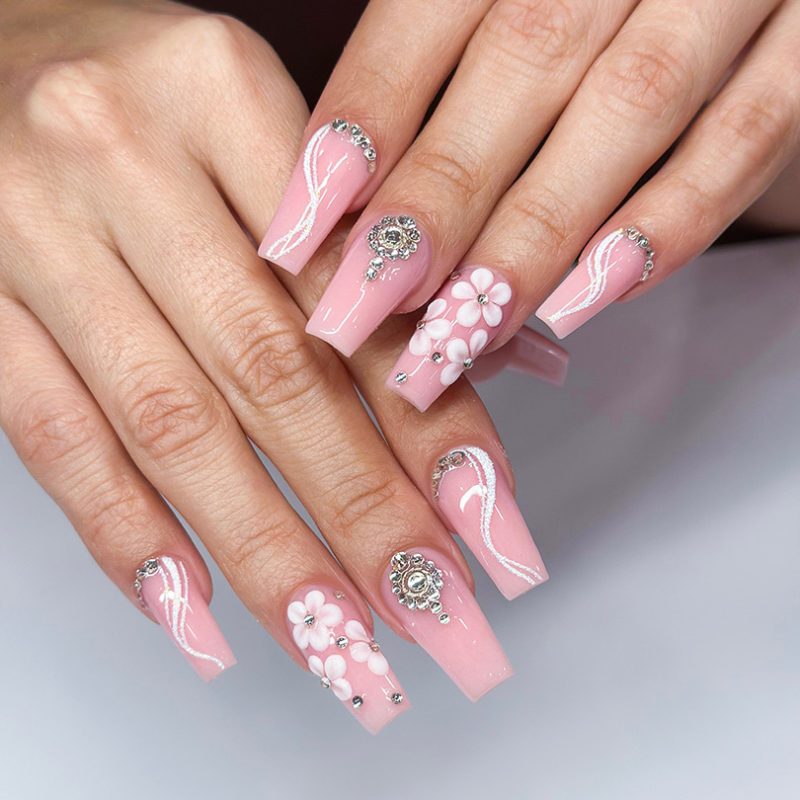 Woman with almond long pink nails design. Manicure. Nail salon. Classic bridal nail design. Summer nails